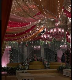 a room decorated with chandeliers and flowers