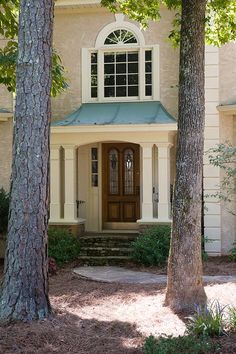 a house with two trees in front of it