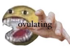 a hand holding an object with the word ovulating in front of it