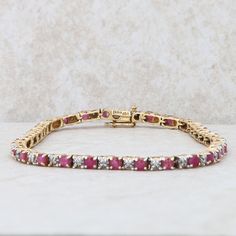 This ladies ruby and diamond tennis bracelet has thirty-four round rubies that measure approx 3.06ct. There are thirty-four round diamonds that measure approx 0.45ctw. The bracelet is 7.5" length and weighs 8.7 grams. The bracelet measures 2.9mm in width and has a figure eight safety catch on the clasp. Condition: Pre-Owned *All items are thoroughly inspected for quality assurance purposes Formal Ruby Gemstone Tennis Bracelet, Luxury Ruby Tennis Bracelet In Yellow Gold, Oval Ruby Gemstone Tennis Bracelet, Classic Ruby Gemstone Tennis Bracelet, Luxury Yellow Gold Ruby Tennis Bracelet, Tennis Bracelet Diamond, Fine Jewelry Bracelets, Wedding Jewelry Bracelets, Tennis Bracelet