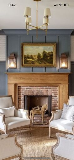 a living room filled with furniture and a fire place in front of a painting on the wall