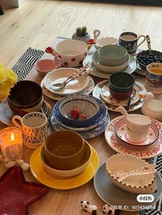 a table topped with lots of plates and bowls