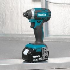 a cordless drill is sitting on top of a metal box with the word makita printed on it