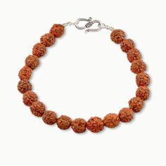 Simple elegance distinguishes our Rudraksha wrist mala made from activated Rudraksha Power Beads, in sterling silver. Known as "Bead of Self Mastery" Rudraksha encourages wise decision making as well as endurance and strength in our endeavors. It magnetizes greater opportunities to us and enhances our ability to fulfill our deepest intentions with strength from within. Activated Rudraksha 7mm Wrist Mala fits a wrist size 6.0" - 7.5" Sterling Silver Ornate S Clasp Made with devotion by traditiona Spiritual Hand Knotted Bracelets With Round Beads, Spiritual Polished Beads Bracelets For Meditation, Spiritual Bracelets With Polished Beads For Meditation, Holistic Hand Knotted Jewelry For Rituals, Spiritual Sterling Silver Beaded Bracelets, Spiritual Sterling Silver Beaded Bracelets With Gemstone, Sterling Silver Spiritual Beaded Bracelets With Gemstones, Silver Beaded Bracelets For Meditation, Spiritual Beaded Bracelets With Sterling Silver Clasp