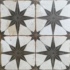 an old tile floor with blue stars on it