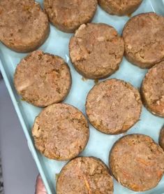 a blue tray filled with carrot cookies on top of a table