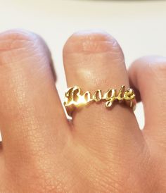 Cursive style name ring in sterling silver or gold over silver, is a perfect statement ring for you. Use this modern name ring also as a knuckle ring (go one size smaller than your regular finger size) or as a Pinky ring. Cursive style name ring comes as a desired word/phrase with a single or two separate rings. 1. Team name. 2. Group name. 3. Sports team name. 4. MEN NAME and many more....( contact me for more info) 5. A.K.A names. All my beautiful name rings and other pieces are proudly made i Affordable Elegant Custom Name Ring, Cheap Elegant Custom Name Ring, Minimalist Custom Name 14k Gold Ring, Dainty Custom Name Ring For Gift, Gold Name Rings As Gift, Name Rings Silver, Woman Rings, Word Ring, Modern Names