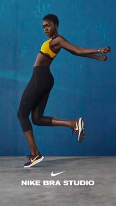 a woman in black and yellow running on a blue background with the nike bra studio logo