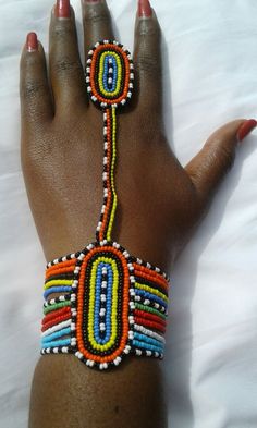 Maasai colours bracelet attached to a ring, carefully hand made with colorful maasai beads.  Please measure your wrist all around in inches, and choose from the drop down menu.  All sandals OR orders 4+ items in your cart qualify for DHL EXPRESS, where Shipping to USA and Canada is 3-4 business Massai Jewelry, African Beaded Bracelets, African Bracelet, Ethno Style, African Accessories, African Necklace, Beaded Ring, Maasai, African Beads