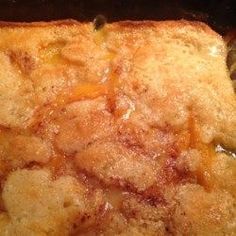 a piece of bread that has been cooked and is sitting on a plate with a spoon in it