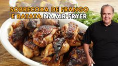 a man standing in front of a bowl full of chicken wings with the caption sorbrecoxa de francisco e bata na air fryer