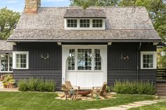 a black house with white trim and windows