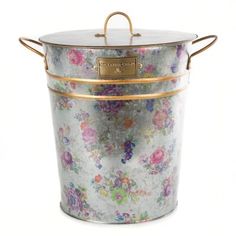 a metal bucket with flowers painted on the outside and gold trimming around the handles