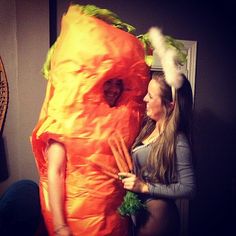 two women dressed up as carrots in the shape of a man and woman hugging each other