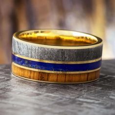 a wooden and metal ring sitting on top of a table