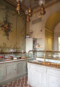 an ornately decorated buffet area in a restaurant with chandeliers hanging from the ceiling