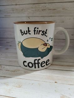 a coffee mug with an image of a sleeping dog on it that says, but first coffee