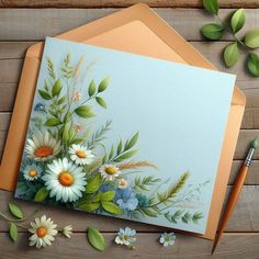 a card with flowers and leaves on it next to a pen, pencil and paper