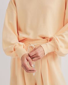 DETAILS: Color: Sherbet Sweatshirt with balloon sleeve detail Super soft fabric Mid-weight terry fabric 54% Cotton, 46% Polyester Machine wash SIZE & FIT: Front length: 22 1/4" Model is wearing size S Oversized Sweats With Elastic Cuffs, Spring Sweatshirt With Elastic Cuffs And Relaxed Fit, Oversized Athleisure Sweatshirt With Elastic Cuffs, Long Sleeve Sweats With Ribbed Cuffs For Spring, Sporty Long Sleeve Tops With Elastic Cuffs, Relaxed Fit Long Sleeve Sweatshirt With Elastic Cuffs, Long Sleeve Sweatshirt With Elastic Cuffs In Relaxed Fit, Long Sleeve Sweats With Elastic Cuffs For Loungewear, Spring Long Sleeve Sweatshirt With Ribbed Waistband