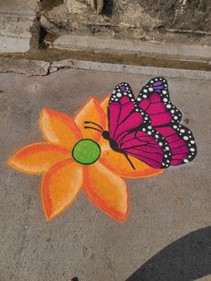 a painted flower with a butterfly on it