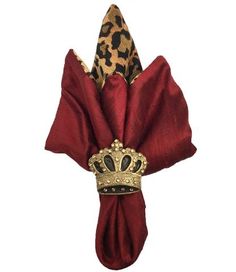 a red napkin with a gold crown on it and a leopard print headband attached to it