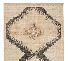 an old rug with black and white designs on the bottom, in front of a white background