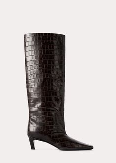 TOTEME boots named after their statement silhouette, which is defined with a wide, tall shaft. They're crafted in Italy from crocodile-embossed leather with a squared point toe and a covered heel, and are lined in soft leather. Keep them in focus by wearing them with midi dresses or by tucking your trousers inside them Wide Shaft Boots, Shaft Boots, Sheep Leather, Clutch Pouch, Leather Mules, Dark Brown Leather, Leather Care, Boot Sandals, Midi Dresses