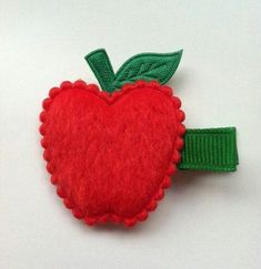 a red apple with a green leaf on it