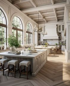 a large kitchen with an island in the middle and lots of windows on both sides