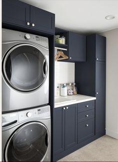 a washer and dryer sitting in a kitchen next to each other on top of cabinets