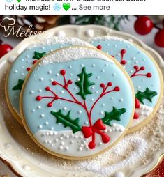 two decorated cookies sitting on top of a white plate