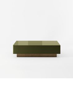 a green and brown table sitting on top of a white floor