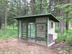 a chicken coop in the middle of a forest