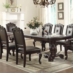 a dining room table with chairs and a chandelier