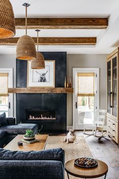 a living room filled with furniture and a fire place in the middle of the room