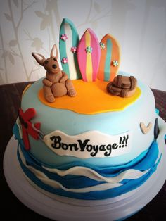 a birthday cake decorated with surfboards and animals