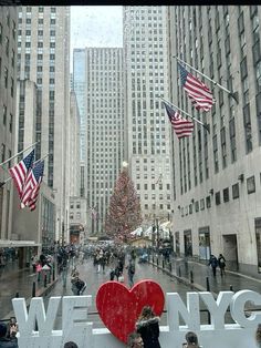 people are walking down the street in new york city with christmas trees and american flags