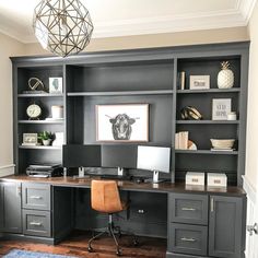 a home office with built in bookcases and desk