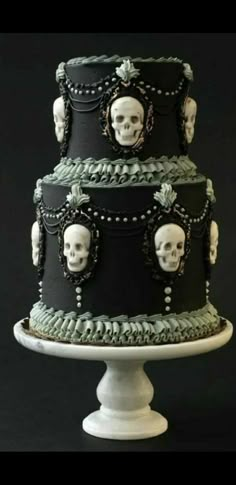 a three tiered cake with skulls on it