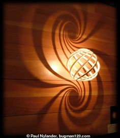 a wooden wall with a light that is on top of it in the shape of a globe