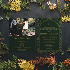 the wedding stationery is surrounded by greenery and pineconis, including evergreens