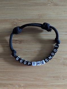 BOOP THE SNOOT bracelet  Black Paracord  Black and white letters Adjustable  One size fits most. If you would like exact measurements please ask or if you would like a custom size just let me know!  Ready to ship! ✈️ Black And White Letters, Bracelet Black, White Letters, Charm Bracelets, Paracord, Favorite Jewelry, Custom Sizing, Beauty Book, Jewelry Bracelets