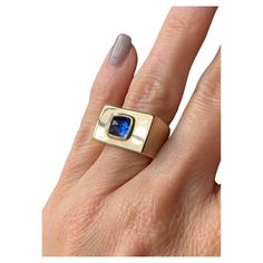 This exceptionally chic bespoke ring showcases a vibrant blue 2.51-carat unheated Ceylon sapphire from the Art Deco era. The sugarloaf sapphire is bezel-set and centered on a softly rounded rectangular face, substantially crafted in 21.9 grams of 14k gold. Accompanied by a gemological report from AGL stating: No evidence of heat enhancement, Ceylon (Sri Lanka) origin. Currently a size 5 1/2. Measurements: 11.56 x 18.74 mm Ceylon Sri Lanka, Bespoke Rings, Ceylon Sapphire, No Heat, Art Deco Era, Vibrant Blue, Signet Ring, Bezel Setting, Metal Jewelry