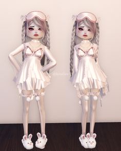 two dolls are standing next to each other on a wooden floor and one is wearing a white dress