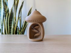 a mushroom shaped object sitting on top of a wooden table