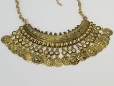 This Turkish Gold Coin Metallic Tribal Ethnic Chunky Bib Choker Statement Necklace is a jewelry made of gold alloy with vintage tribal tassel coin charms design. The choker bib is a perfect statement jewelry piece for women that will bring together and enhance any outfit. Laboutiquedacula offers a specialized customer service team that is available seven days a week to answer any product questions before, during or after the purchase. Find a special gift for a loved one or a beautiful piece that Statement Choker Necklace, Gold Alloys, Gold Coin, Seven Days, Gold Coins, Statement Jewelry, Jewelry Pieces, Special Gifts, Choker