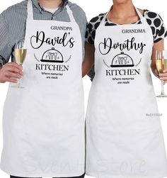 two people wearing aprons holding wine glasses