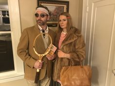 a man and woman dressed up in costumes holding tennis racquets