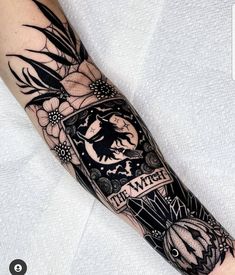 a man's arm with a tattoo on it that says the witch and flowers