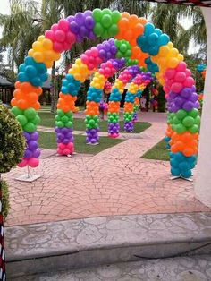 an archway decorated with balloons and streamers